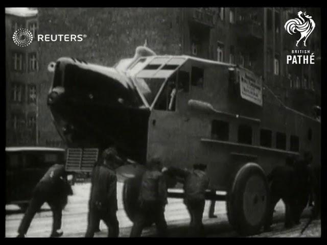 GERMANY: Rohrbach-Roman Aeroplane through city. (1929)