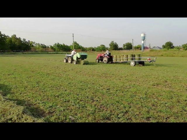 The fifth hay mowing. They press their baler 0850. Minitractor on hay harvesting.