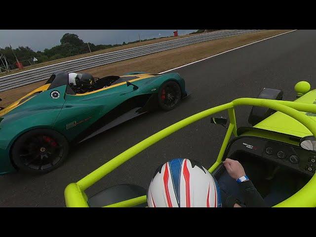 Caterham 620r with Lotus 311 going through traffic at Oulton Park