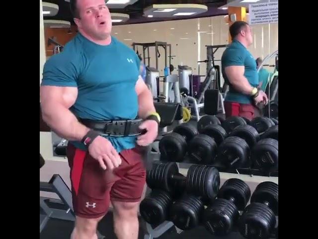 Giant muscle bull with broad back and big glutes pumping iron