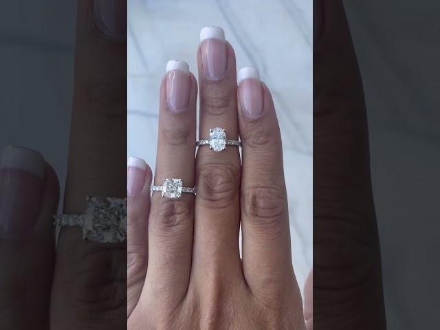 2 carat cushion cut diamond 1.5 carat oval diamond engagement ring comparison on a hand