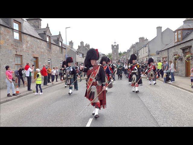 Chieftain leads the massed Pipes and Drums on the march to 2023 Dufftown Highland Games in Scotland