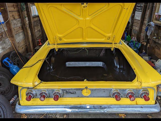 Rocker guarding a trunk.  The 1962 Comet gets its trunk cleaned up.