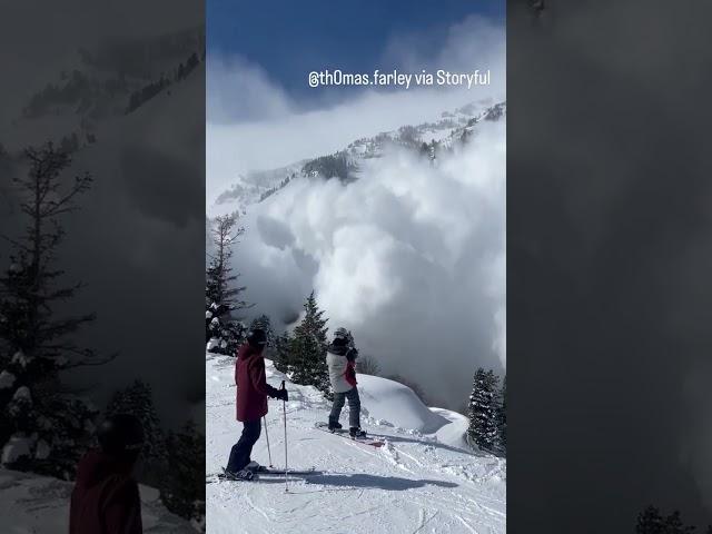 Massive avalanche tumbles toward skiers