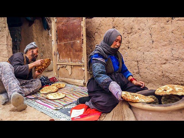 Making tandoor and baking bread in it. Afghan caveman couple