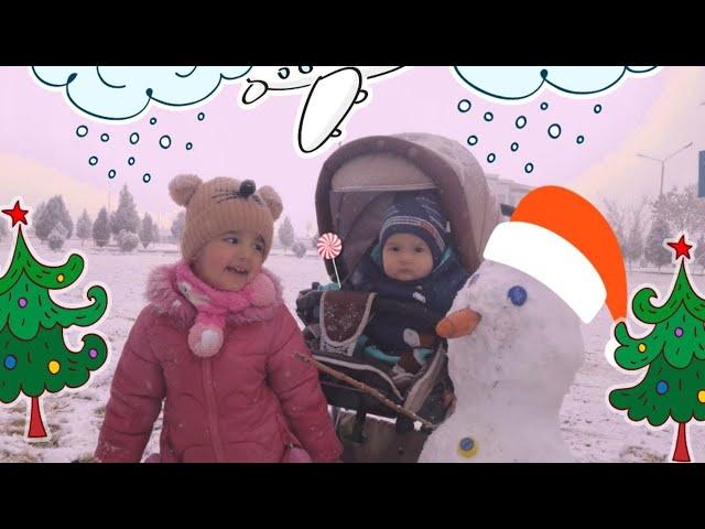 Mubina and Family play with snow and sculpt a snowman