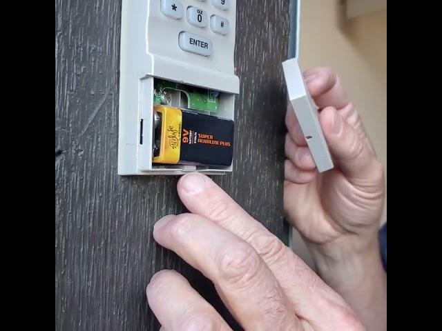Removing Liftmaster garage door keypad battery cover.