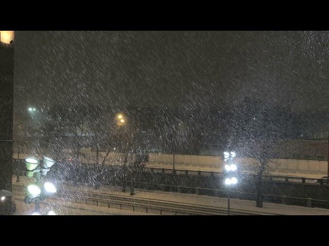 Snowfall and blizzard in Moscow in the bright spotlights