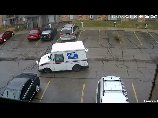 How difficult is it to look? Car backs into postal vehicle truck.