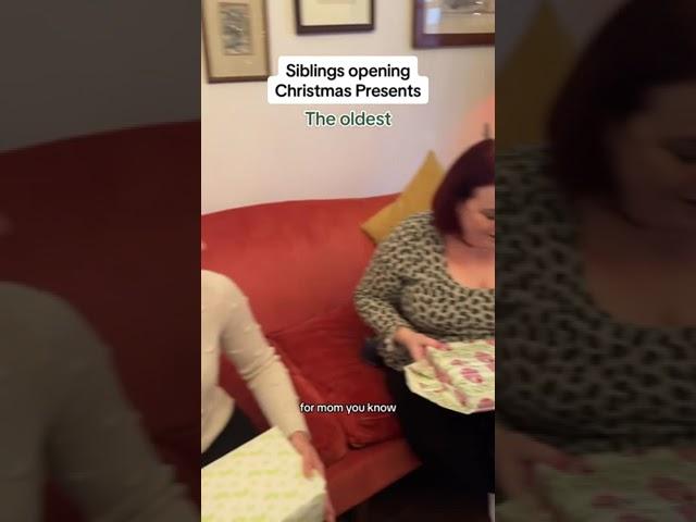 Siblings opening Christmas presents