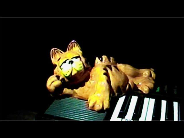 cheesy ceramic Garfield lounging on the keyboard