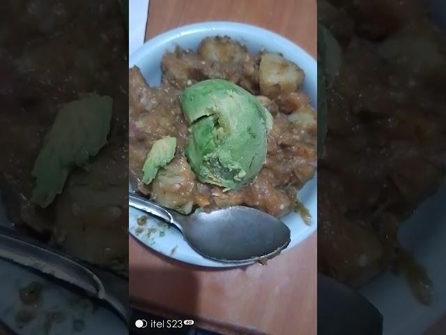 Eating matoke with avocado, MercyNguku The World Traveller 