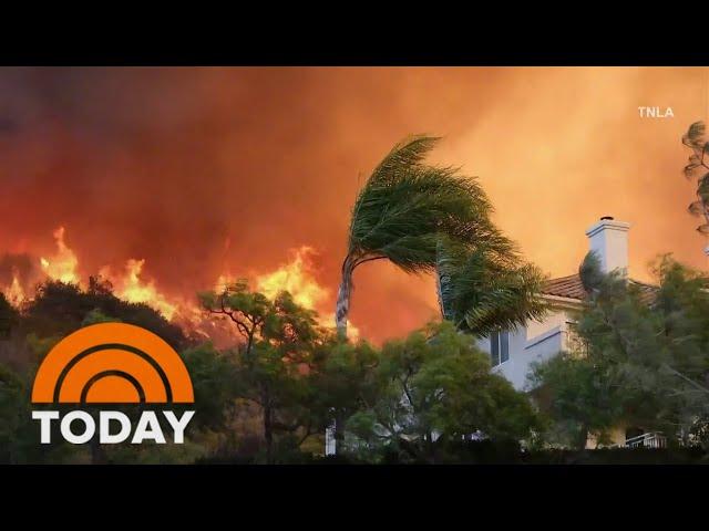 Firefighters race to contain LA wildfires before winds pick up again