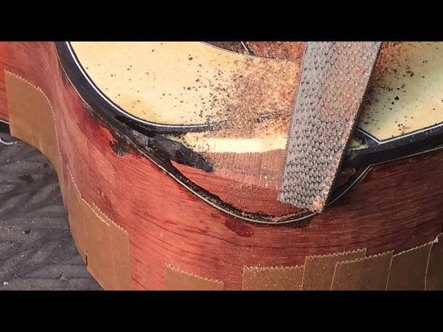 Shaping a scoop cutaway with a rasp before veneering Beau Hannam guitars ukuleles