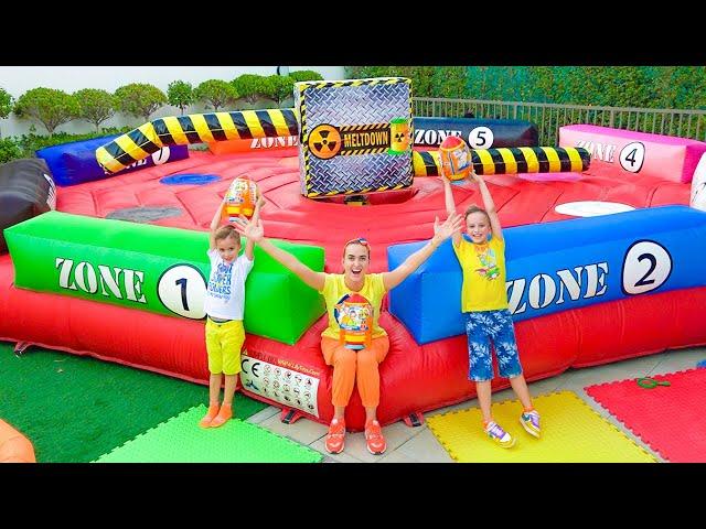 Mom helps Vlad and Niki find toys on the inflatable slides