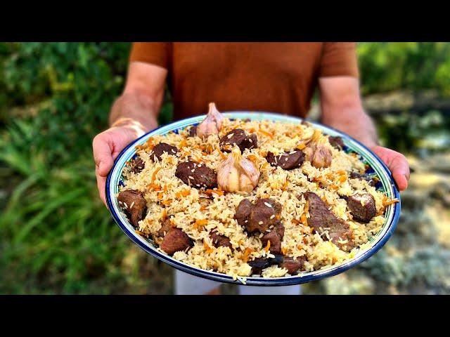 UZBEK PLOV from mutton in a cauldron.