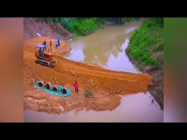 A small bulldozer and a small excavator worked together to successfully intercept the flow.