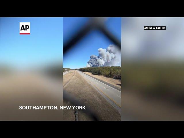 Cellphone footage captures active brush fire on New York's Long Island shooting smoke into the sky