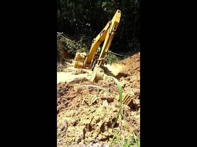 Dumb Trinidad excavator driver stuck in river