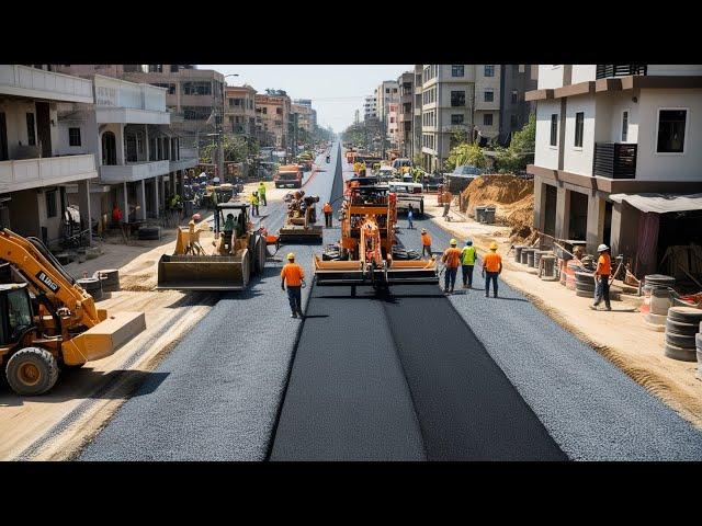 Amazing Gravel paving machinery with construction workers and equipment actively working on the road