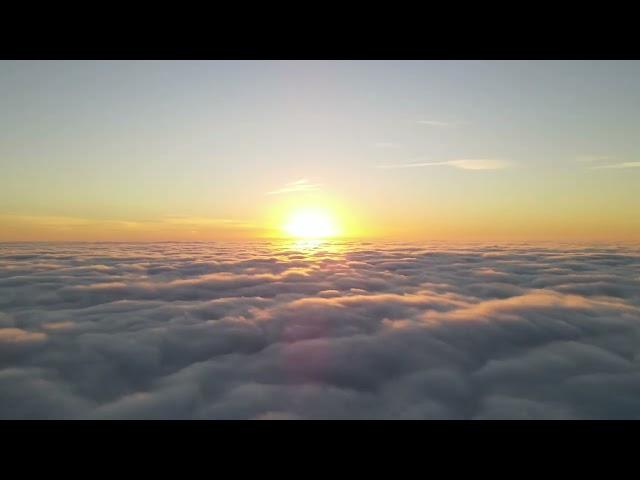 Drone time lapse video of sunrise above the fog