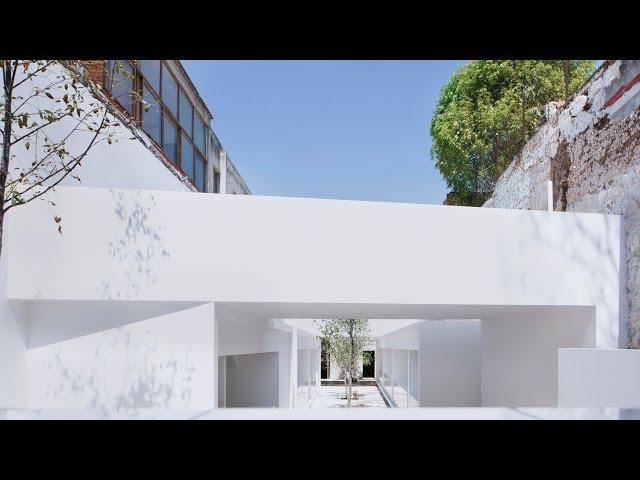 White volumes by HW-Studio form food market between stone buildings in Mexico