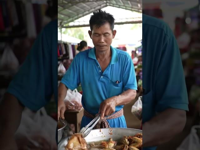 a man cooking fried chicken