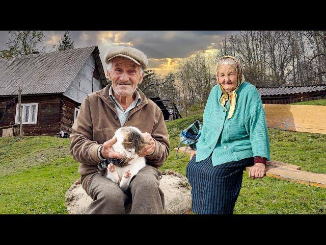 Happy old age of an elderly couple in a mountain village far from civilization