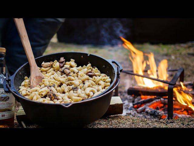 Outdoor cooking in the forest - Petromax dutch oven campfire casserole with whisky