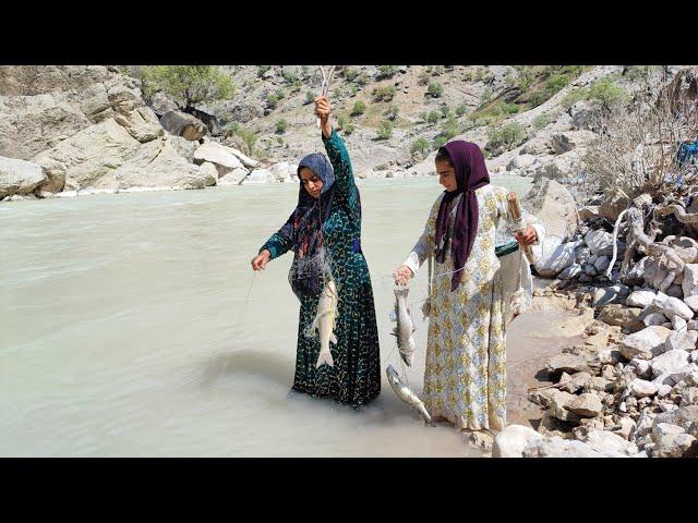 Fishing in the raging river by a young nomadic woman