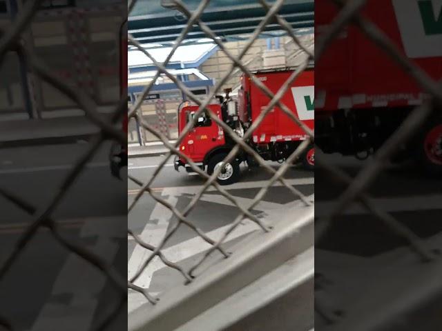 A Red Waste Management Mack MRU Mcneilus RL trash truck