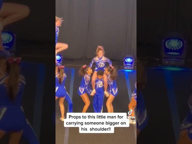 kid carry cheerleader on shoulders.