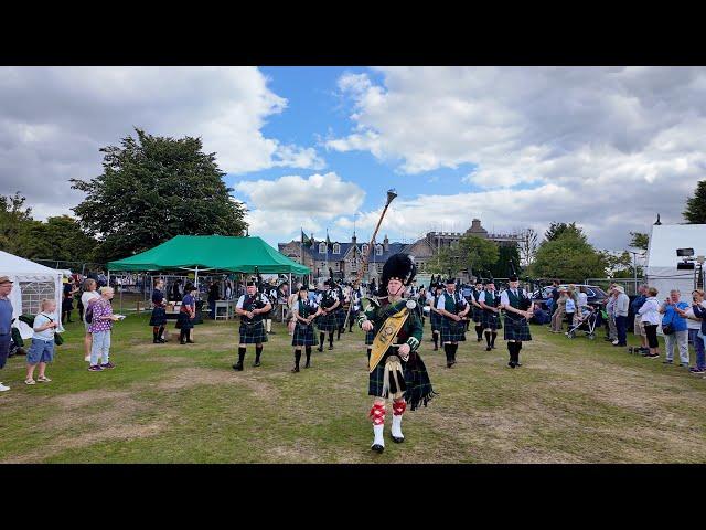 Drum Major leads Huntly Pipe Band playing King Charles III marching into 2024 Aboyne Highland Games