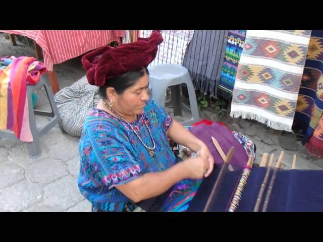 Maya woman in Guatemala creates a hand made blanket and clothing one thread at a time.