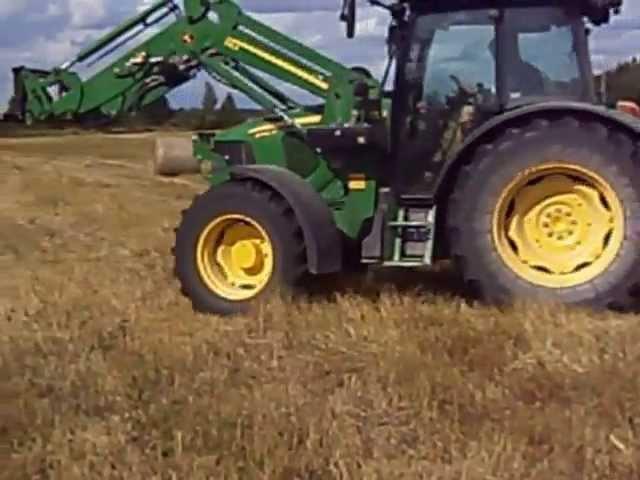 Collecting hay bales.