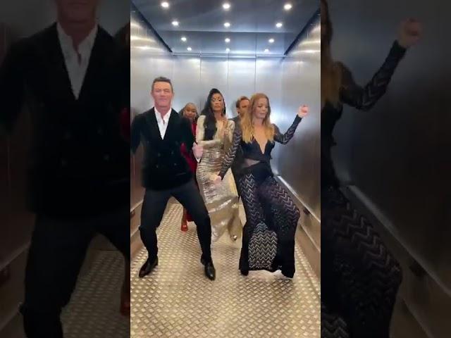 Luke Evans, Olly Murs, Beverley Knight, Nicole Scherzinger and Leean Rimes dance in an elevator.