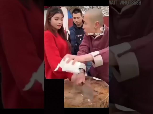 Black Chinese demonstrating insane sharp knife.