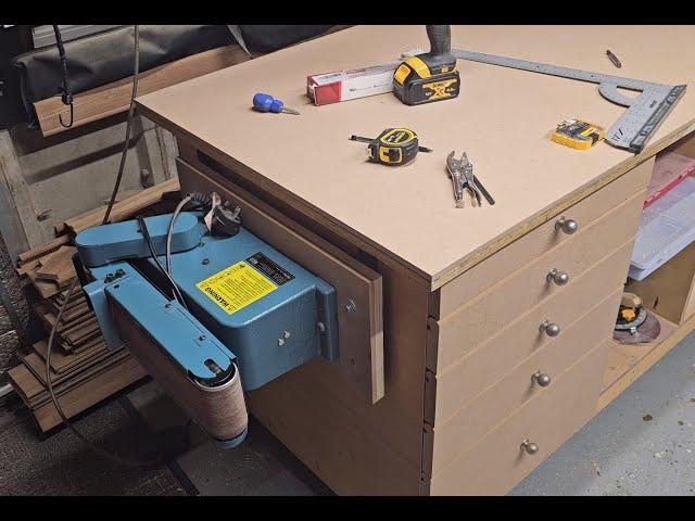 Fitting my bench sander onto a folding shelf.