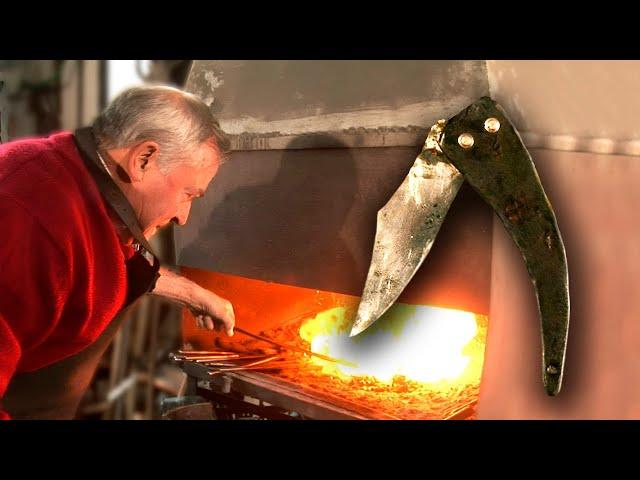 Shepherd's knife with an old scythe and goat horn. Artisanal forging in the forge