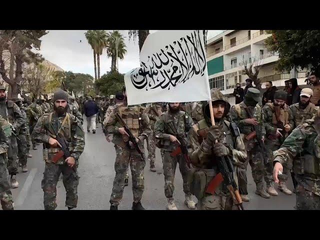 Hundreds of Syrian armed rebels parade in Damascus as a show of force