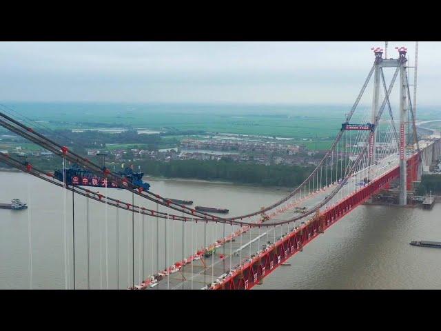 GLOBALink | China's 1st double-deck cable-stayed suspension bridge completes closure