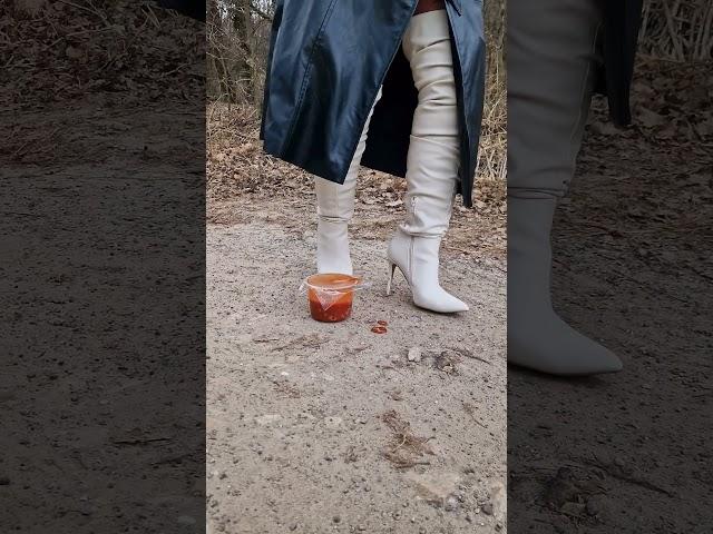 Thigh high high heel boots crushing tomato soup. Boot being sprayed by the soup. #boots #heels