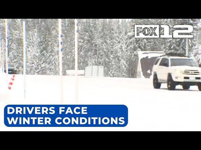 Drivers chain up to travel Cascades passes amid snowstorm warning