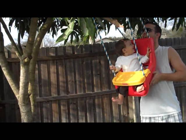 Ethan in his swinger with daddy  9months