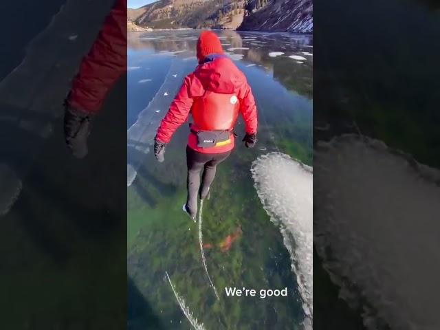 Woman ice skates on frozen lake as the ice starts to crack