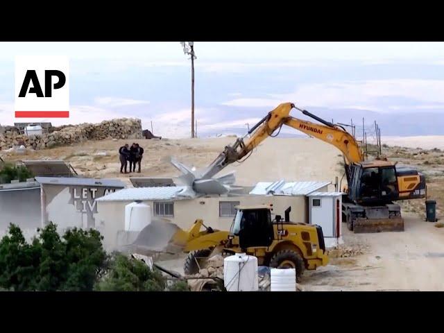 Israeli bulldozers demolish houses in the West Bank, making dozens homeless
