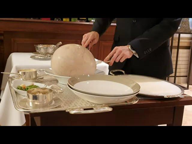 Table serving Bresse chicken cooked in a bladder ‘à la Mère Fillioux’ at 3 Michelin star Paul Bocuse