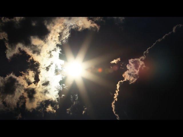 Sun Burst Between Erie Clouds Time Lapse - Royalty Free HD Stock Video Footage.