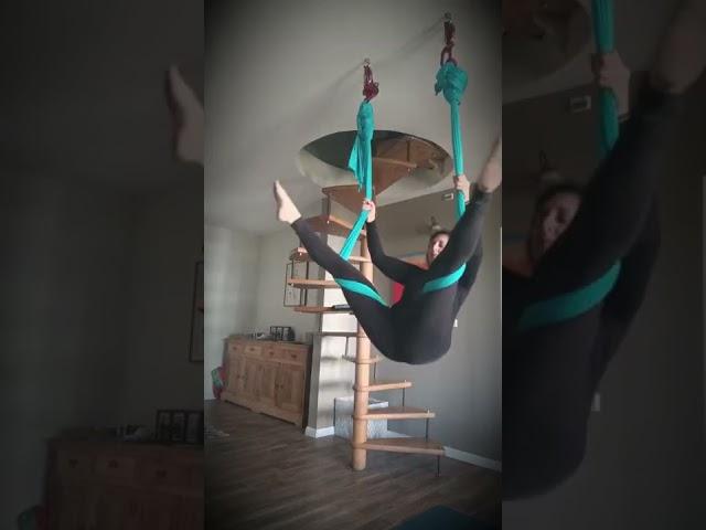 Aerial yoga trick from key straddle