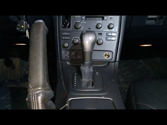 Volvo S60, S80. Removing the handle cover, automatic transmission, and Parking brake.